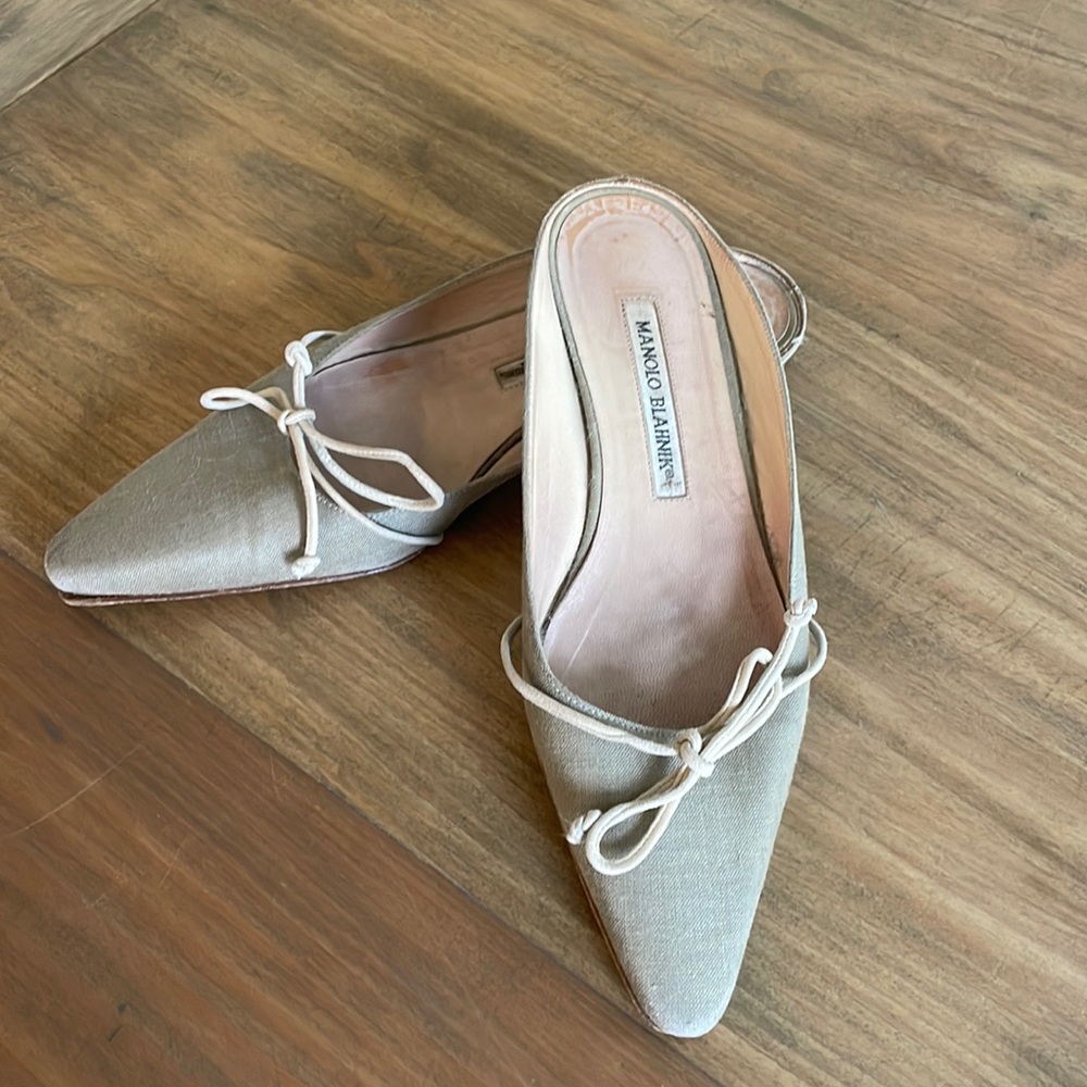 Manolo Blahnik flat pointed toe mules with bow ties.